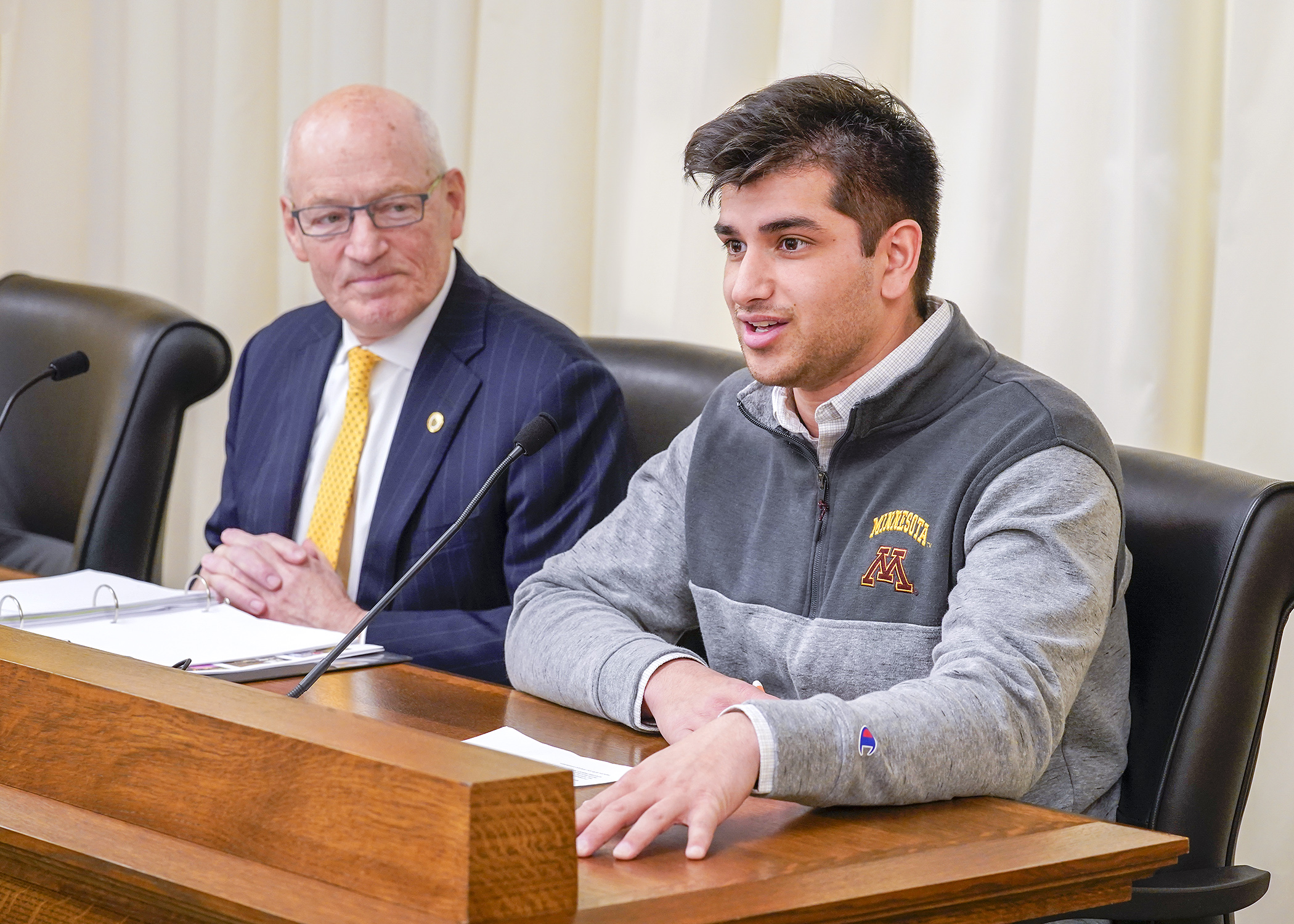 U of M student Mustafa Syed testifies Jan. 18 before House lawmakers with Myron Frans, the school’s senior vice president for finance and operations, during a presentation on asset preservation and replacement needs. (Photo by Andrew VonBan)